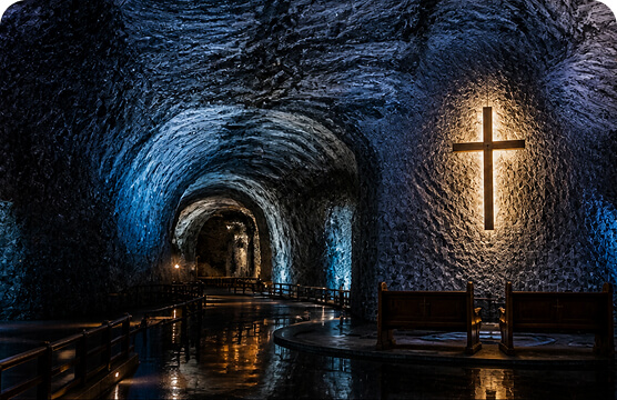 Interior of the Salt Cathedral of Zipaquirá with an illuminated cross.