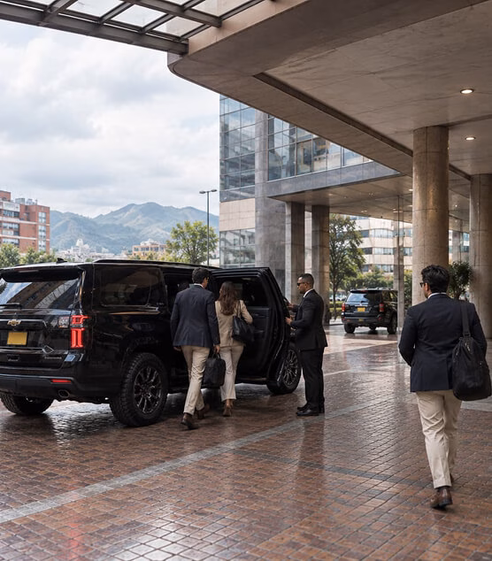 White executive-style Toyota Fortuner SUV, parked in front of a brick building.
