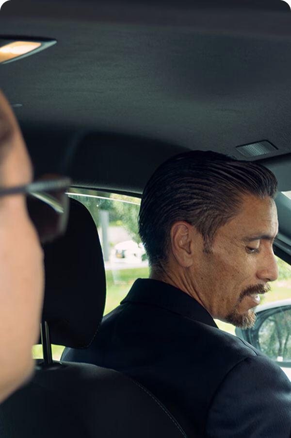 Point-to-point transfers-img Two men in the back seat of an executive vehicle during a transfer.