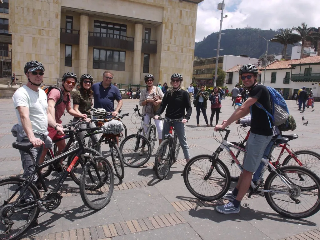 Riders in helmets gathered on their bikes in a Bogota square