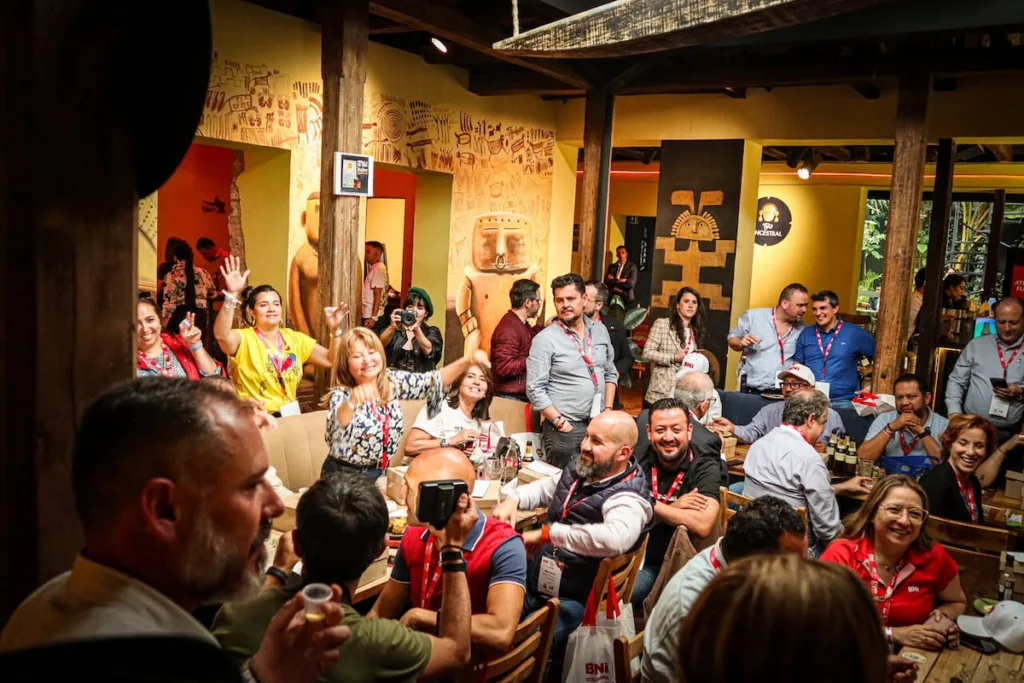 A crowded tejo bar in Bogota with tables of people watching the game