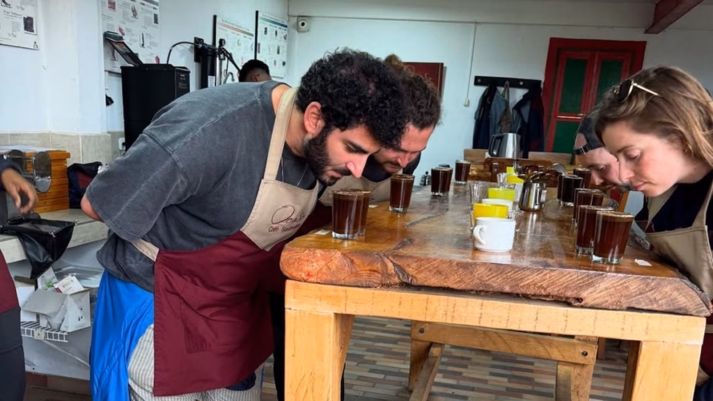 Travellers smelling freshly ground coffee at a farm near Salento