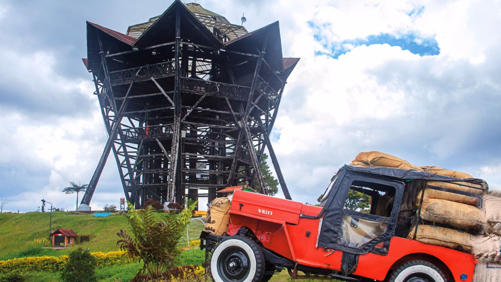 A Willys jeep loaded with coffee sacks beside the Filandia lookout tower