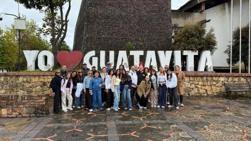 A tour group in front of the Yo Amo Guatavita letters in the town square