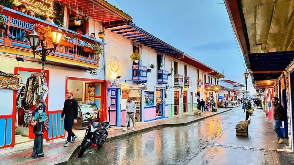 People walking along a colourful street in Salento, Quindio