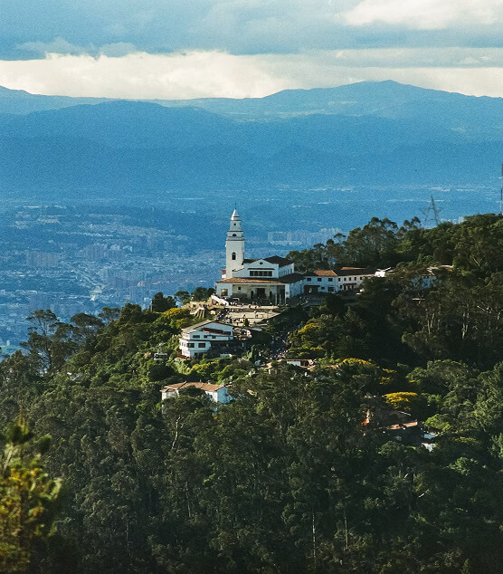 Panoramic view of Bogotá from Monserrate hill, with the sanctuary among the greenery.