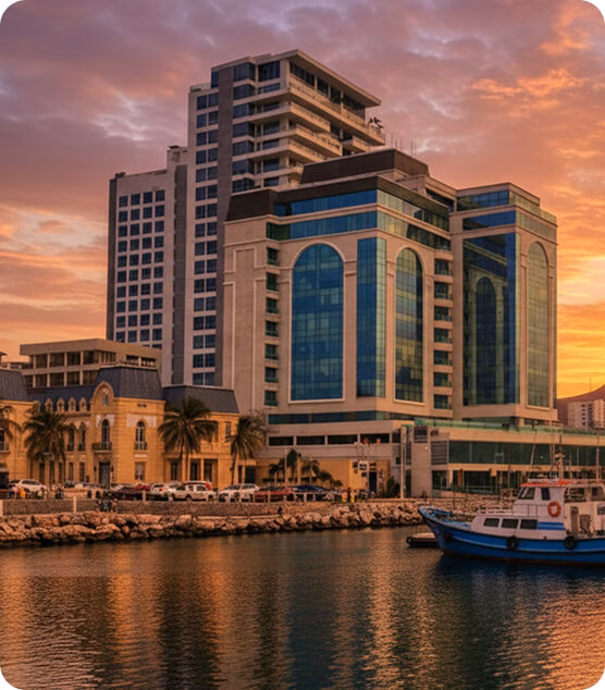 Santa Marta skyline at sunset, with modern and colonial buildings facing the bay.